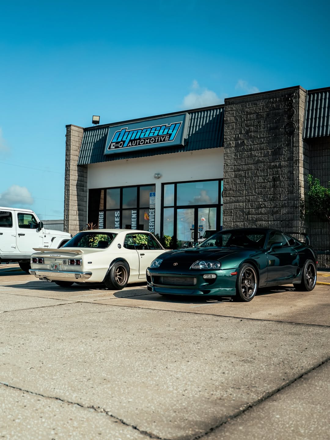 Dynasty Automotive storefront with Kenmeri Skyline and MK4 Toyota Supra out front